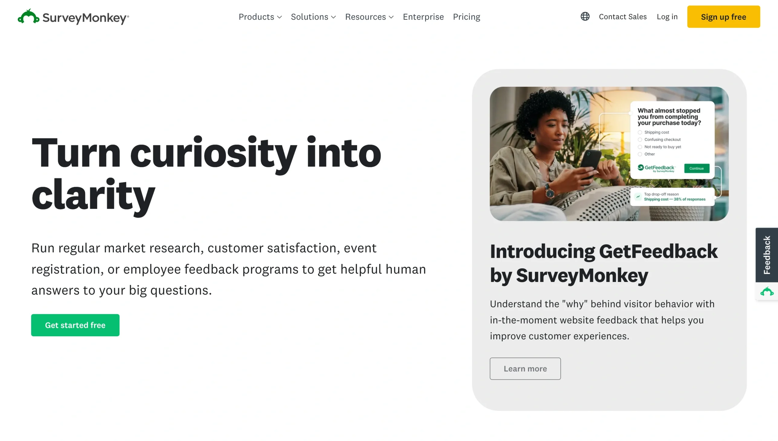 Screenshot of the SurveyMonkey landing page, showing a headline "Turn curiosity into clarity"