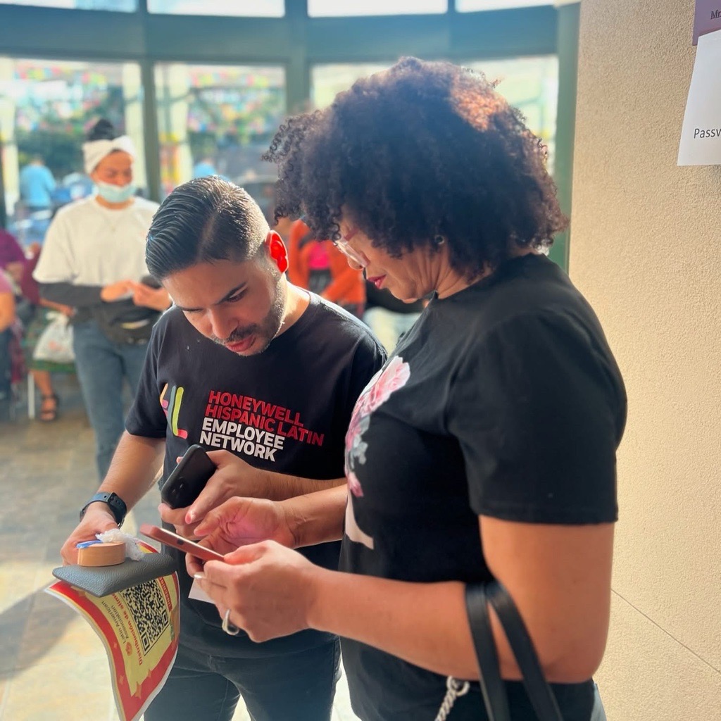 Two people filling out a form on a phone