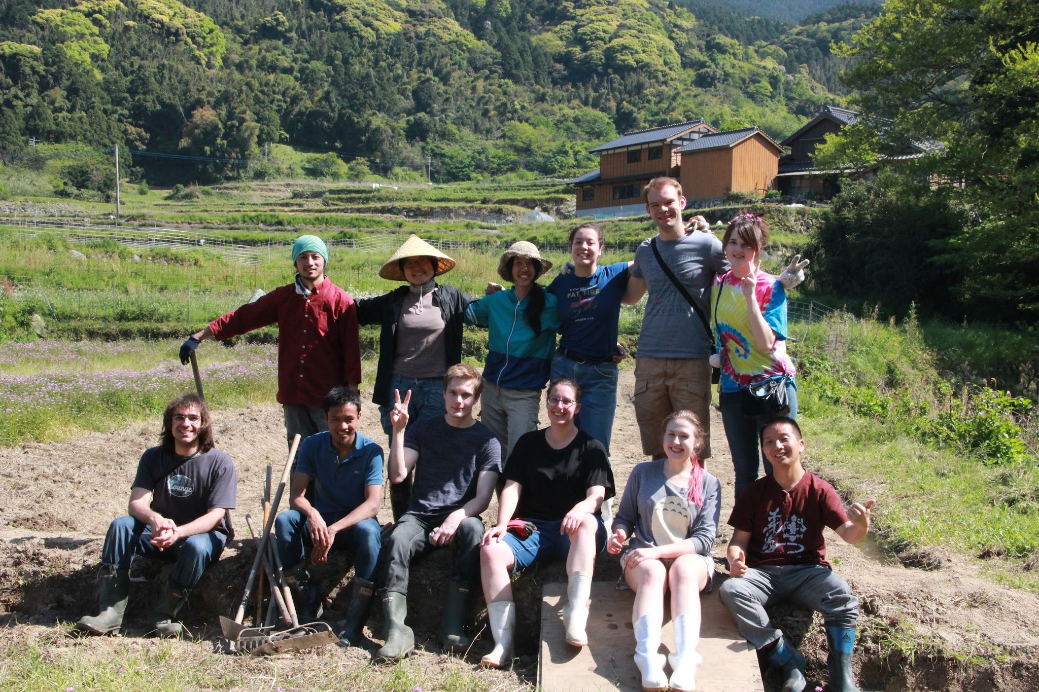 A group of GenkiJACS students pose for a photo at a rice farm in Fukuoka, Japan, near the GenkiJACS campus